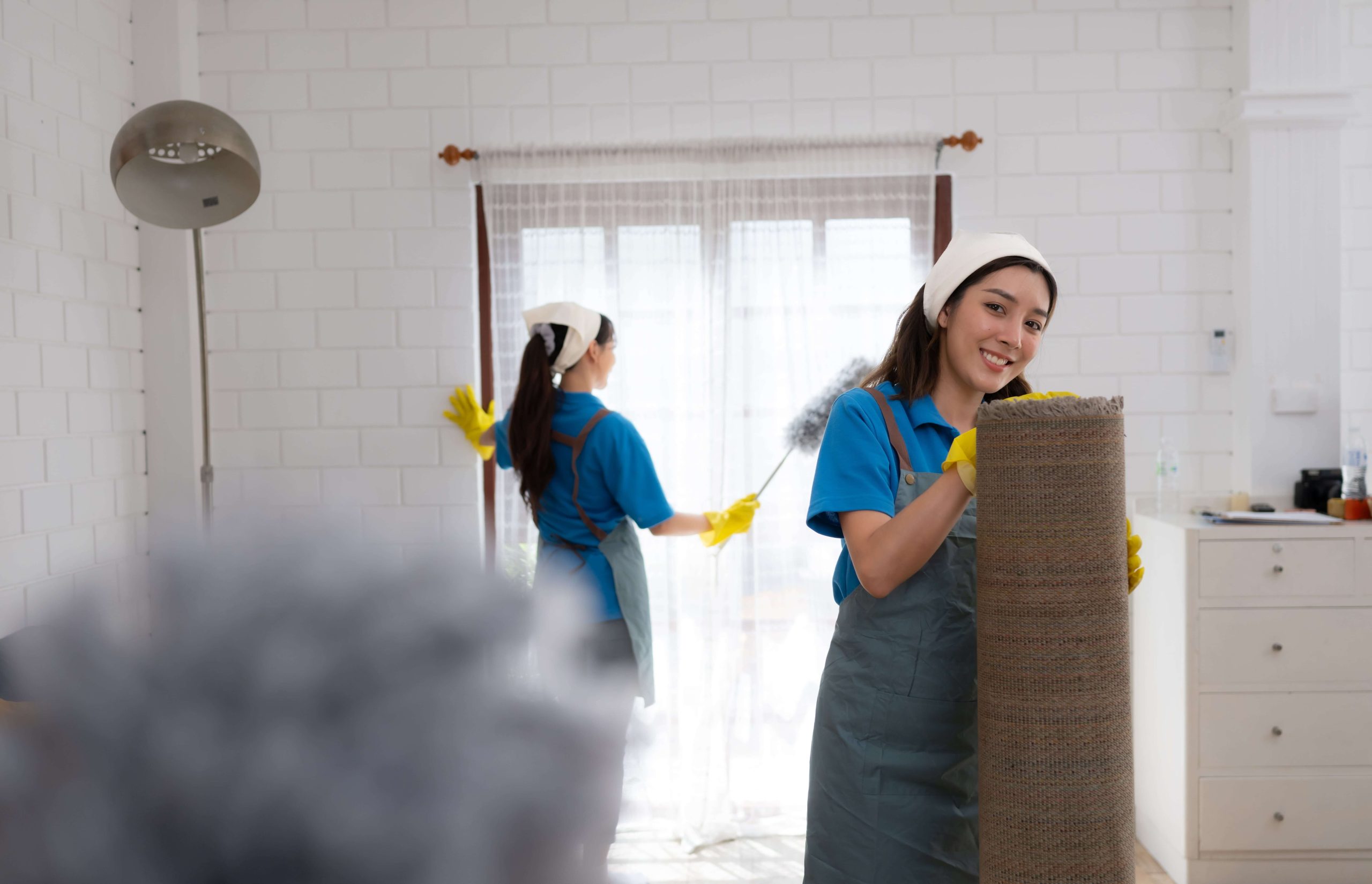 asian-young-woman-cleaning-window-in-the-living-ro-2025-01-08-17-41-22-utc-min