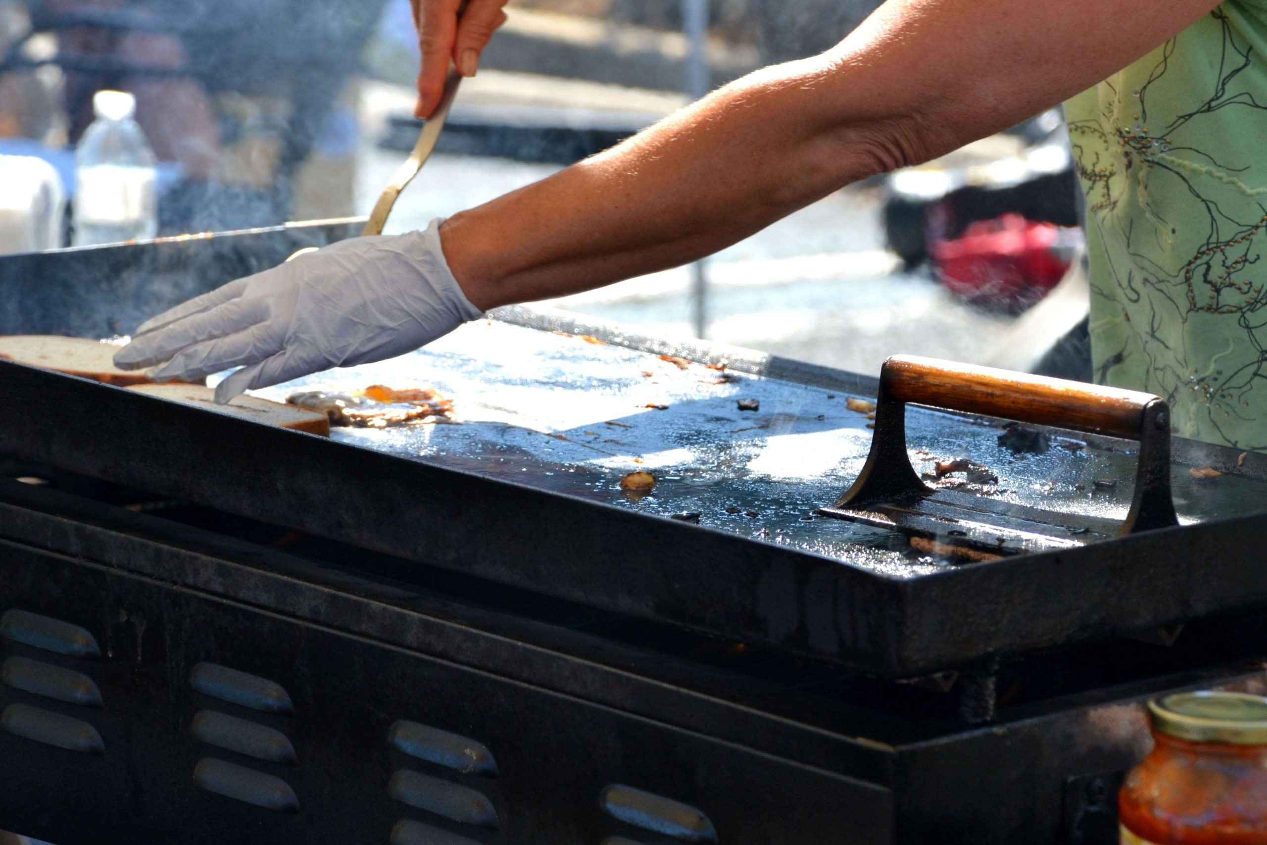 woman-frying-food-on-a-hot-griddle-at-an-outdoor-f-2025-03-11-18-31-04-utc-min woman-frying-food-on-a-hot-griddle-at-an-outdoor-f-2025-03-11-18-31-04-utc-min